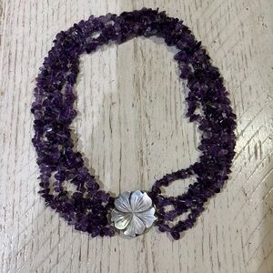 Amethyst multi strand chip bead necklace with mother of pearl flower clasp.